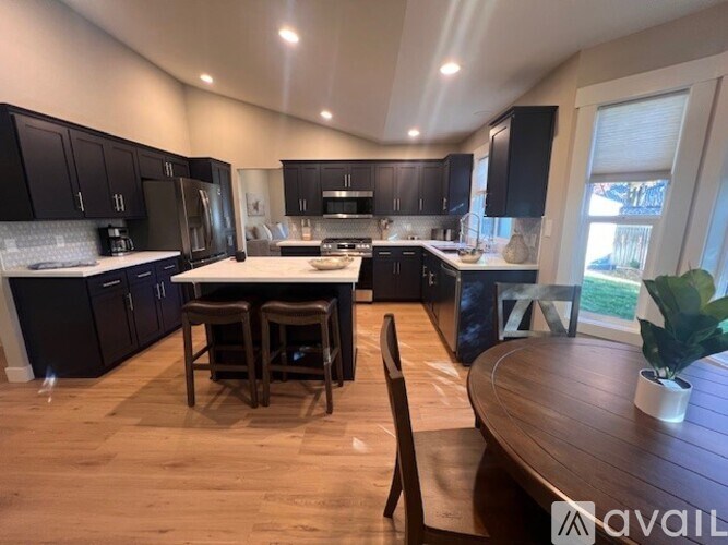 A kitchen with dark wood cabinets and stainless steel appliances.