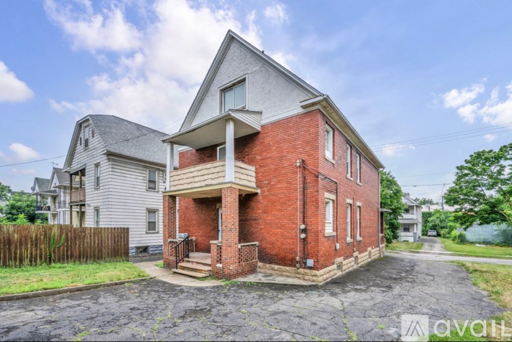 A brick house with a porch and a garage door.