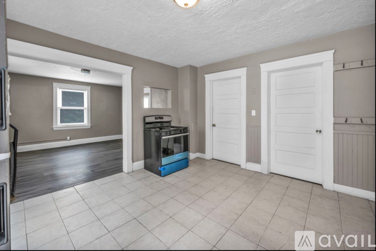 A kitchen area with a dishwasher and a window.