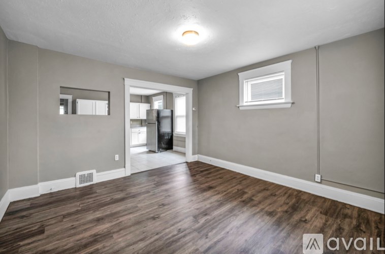 A room with wooden flooring and a window.