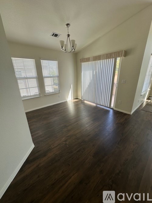 A room with wooden floors and a chandelier.