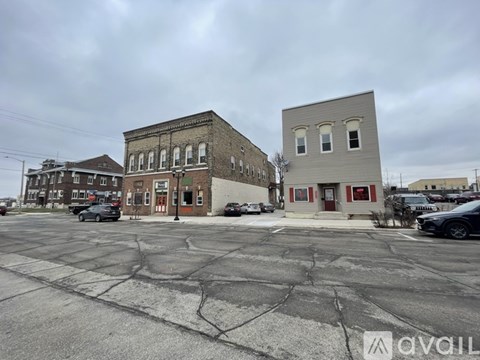 A parking lot with a building in the background.