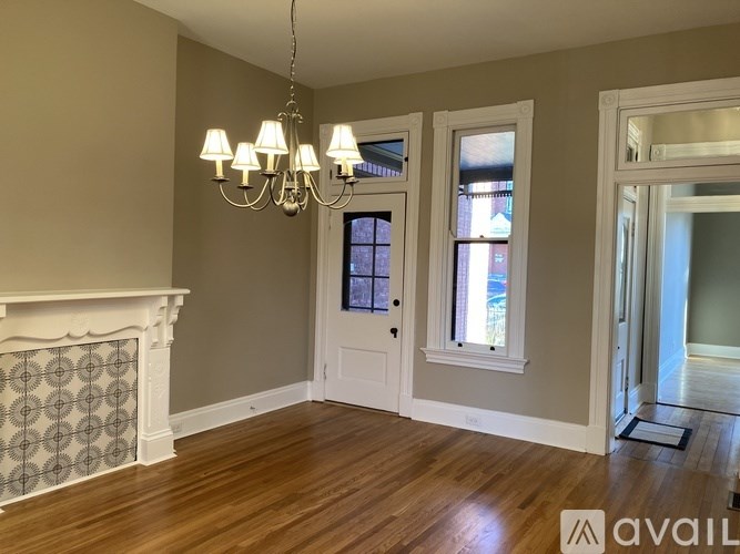 A room with a fireplace and a chandelier.