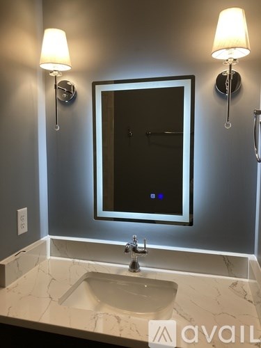 A bathroom with a sink and a mirror.