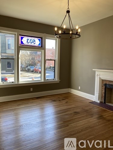 A room with a fireplace and a chandelier.