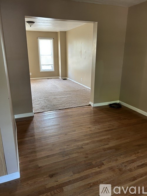 A room with wooden floors and a window.