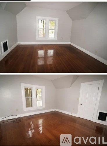 A room with wooden floors and a white door.