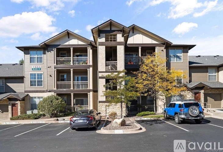 A large apartment complex with a car parked in front.