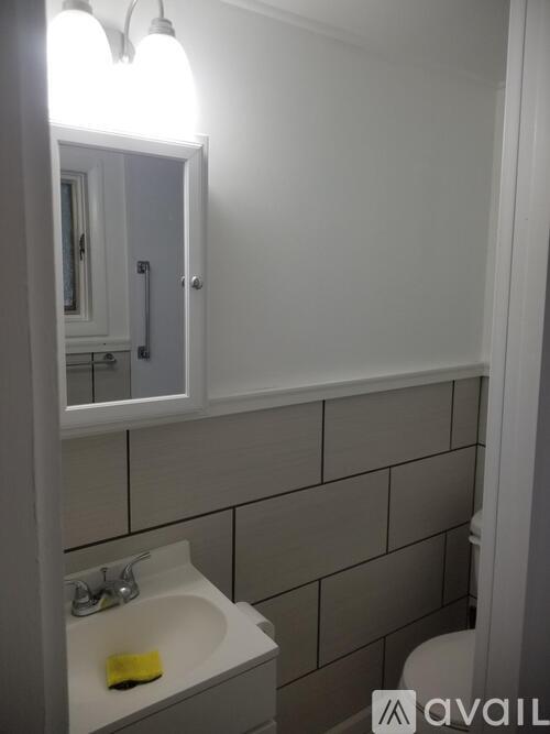 A bathroom with a sink, mirror, and toilet.