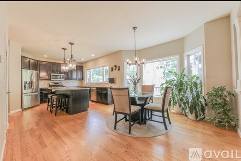 A modern kitchen with a bar area and a dining table set up.