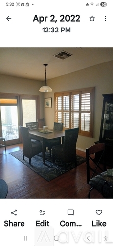 A dining room with a table and chairs.