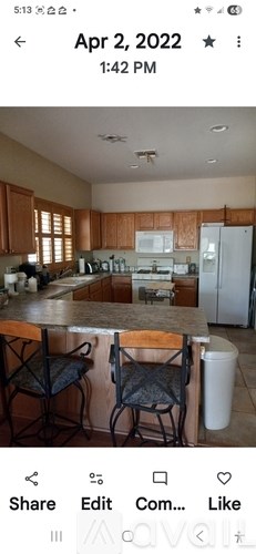 A kitchen with wooden cabinets and a white refrigerator.