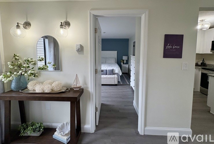 A room with a table and a mirror on the wall.