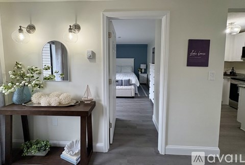 A room with a table and a mirror on the wall.