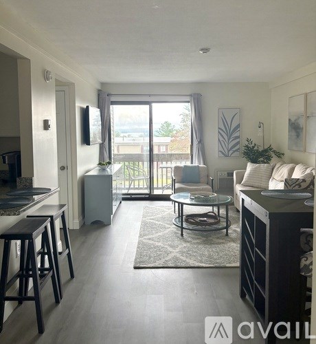 A living room with a glass table and a couch.