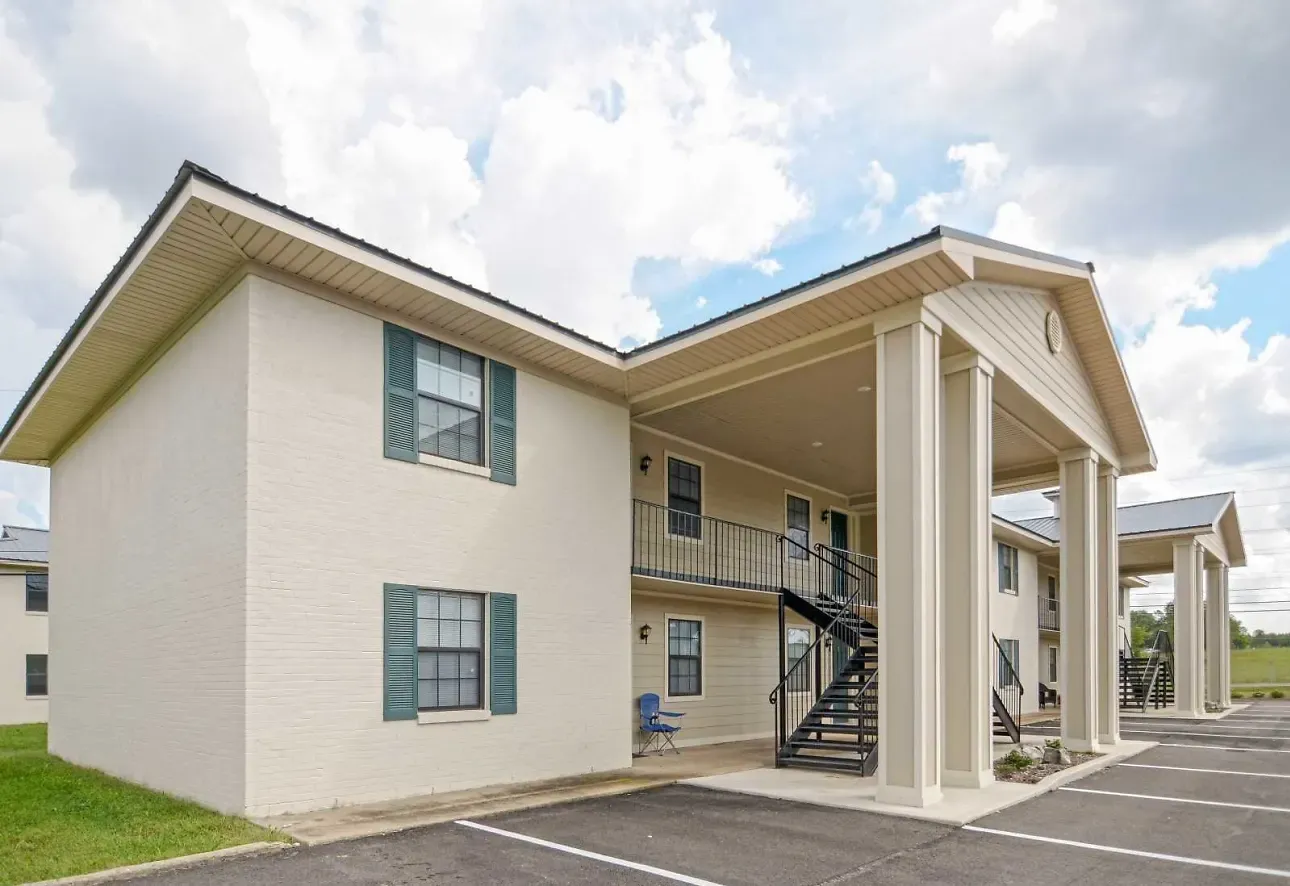 A two-story building with a balcony and a staircase leading to the second floor.