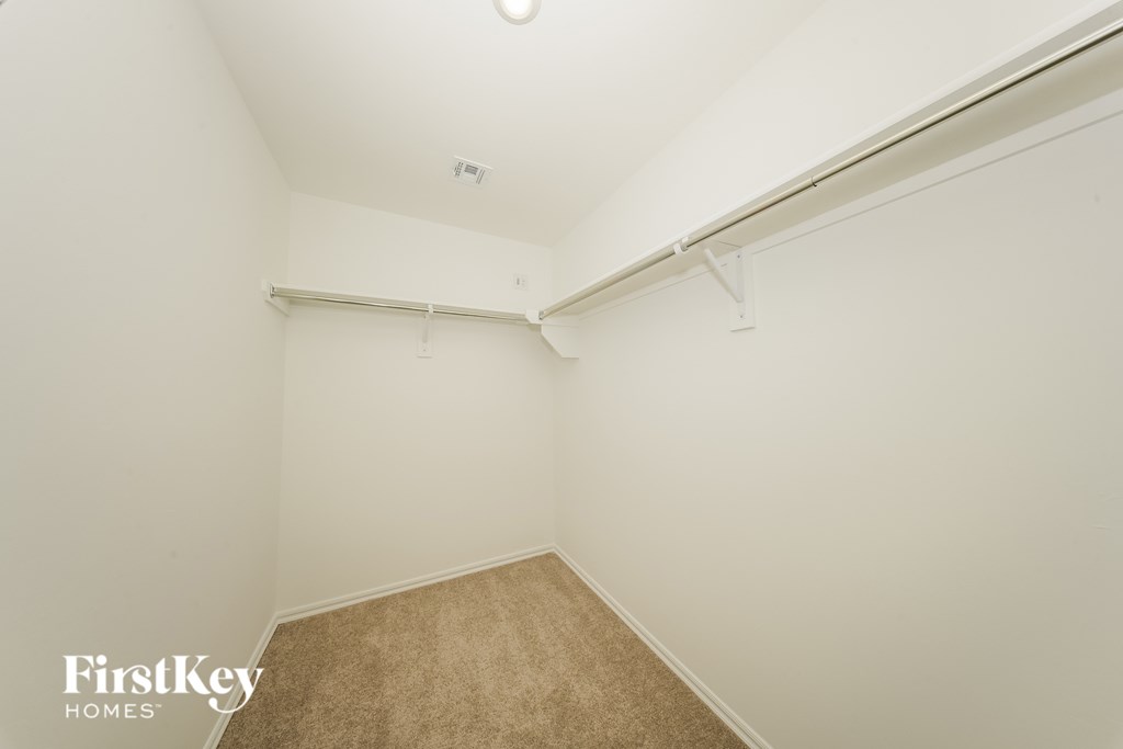 A room with a carpeted floor and a white wall.