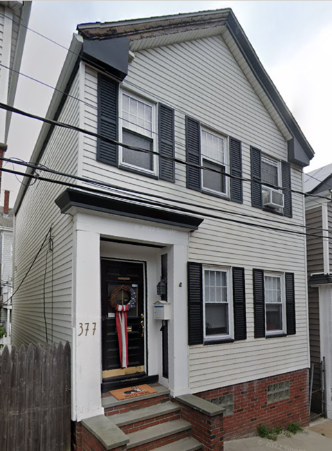 A house with the number 377 on the front door.