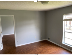 A room with a wooden floor and a window.