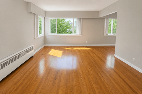 A room with wooden floors and white walls.