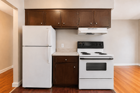 A white refrigerator and a white stove in a kitchen.