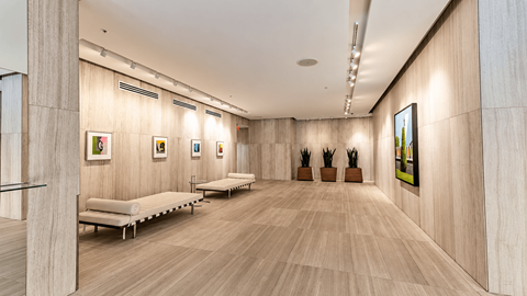 A spacious room with wooden floors and benches.