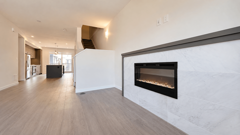 A modern living room with a fireplace and hardwood floors.