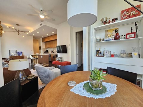 A dining room with a wooden table and chairs.