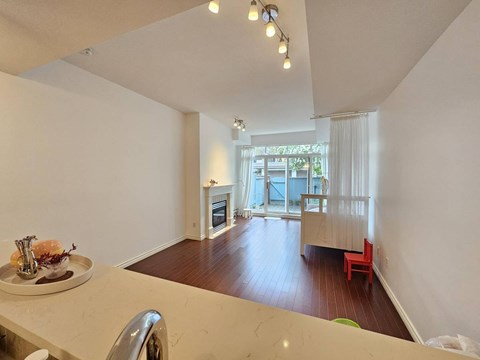 A kitchen with a table and chairs in front of a window.