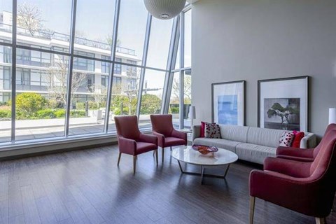 A living room with a couch, two chairs, and a coffee table.