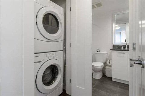 A white washing machine and dryer in a small laundry room.