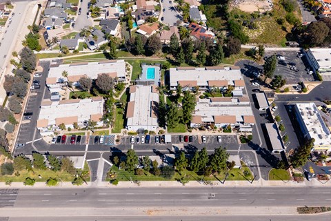 A parking lot with cars and a building in the background.