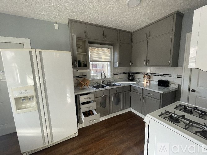 A kitchen with a white fridge and a white stove.
