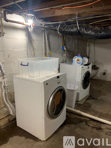 A washing machine and dryer in a basement.