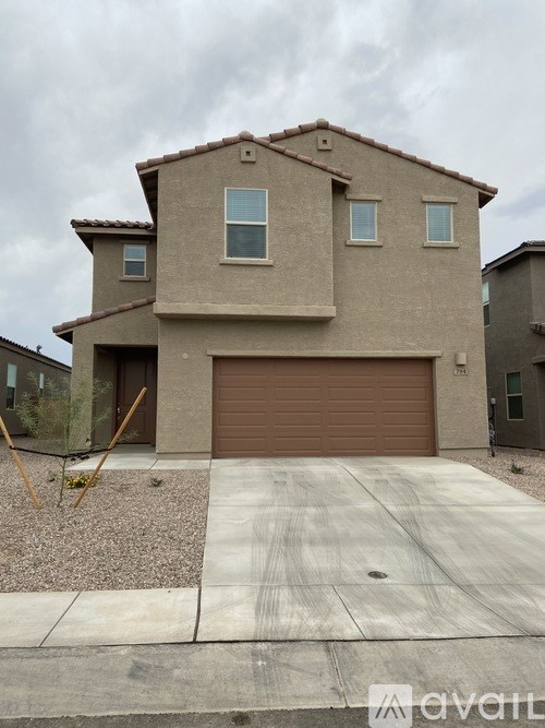 A beige house with a brown garage door.
