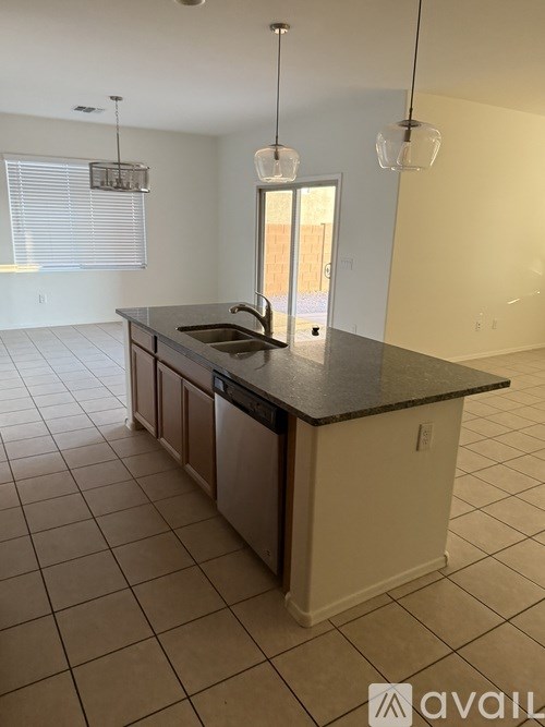 A kitchen with a black countertop and white cabinets.
