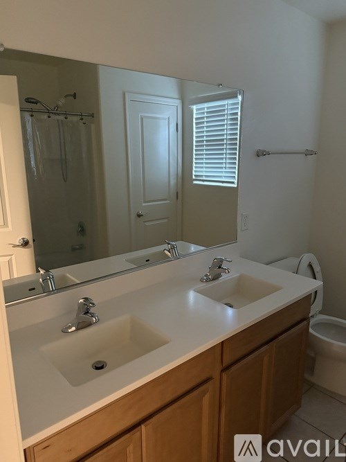A bathroom with a sink, mirror, and toilet.
