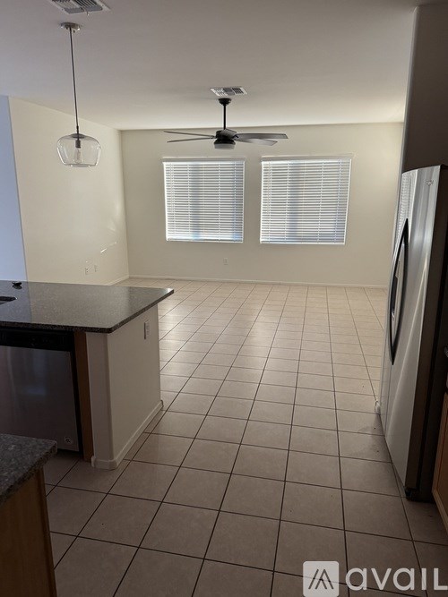 A kitchen with a black counter top and a white fridge.