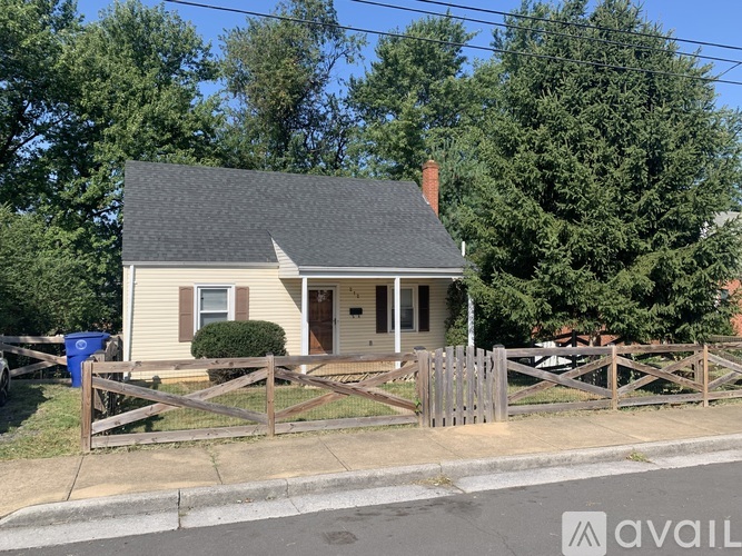 A small house with a fence in front of it.