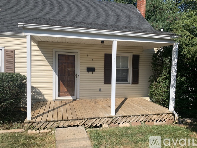 A house with a porch and a mailbox on the front door.