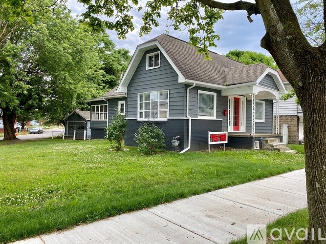 A house with a red door is for sale.