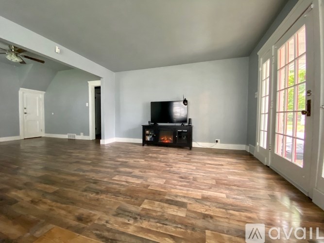 A living room with a television and a fireplace.