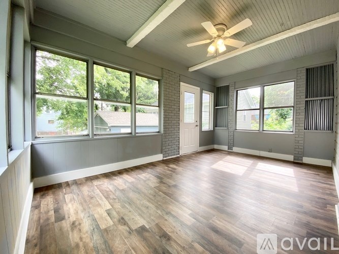 A room with wooden floors and a ceiling fan.