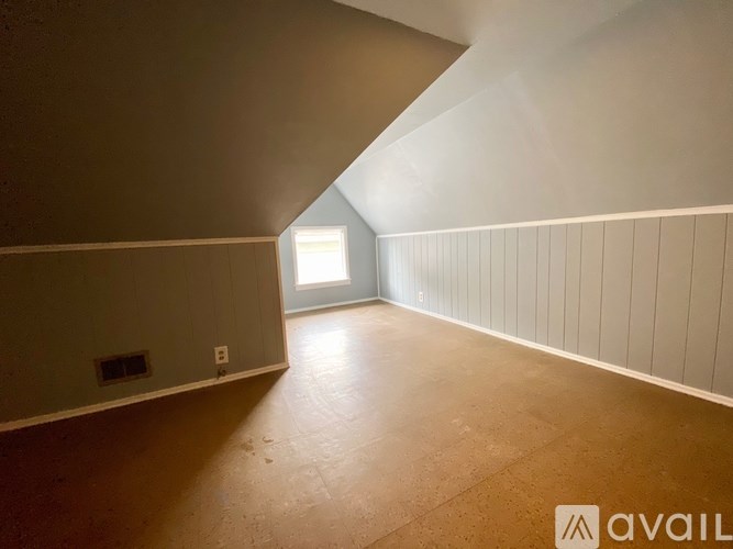 A room with a window and a wall with a logo that says "AVAIL".