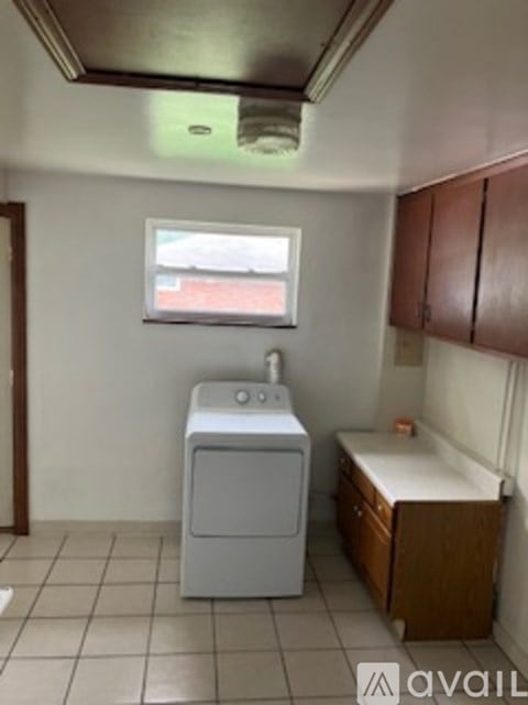 A small laundry room with a washer and dryer.