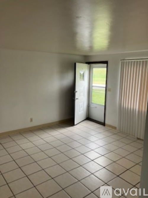 A room with a tiled floor and a sliding glass door.