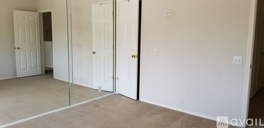 A room with a carpet floor and a glass door.