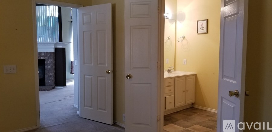 A bathroom with a toilet and sink is visible through an open door.