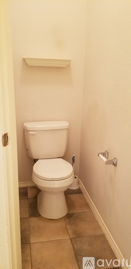 A white toilet in a small bathroom.