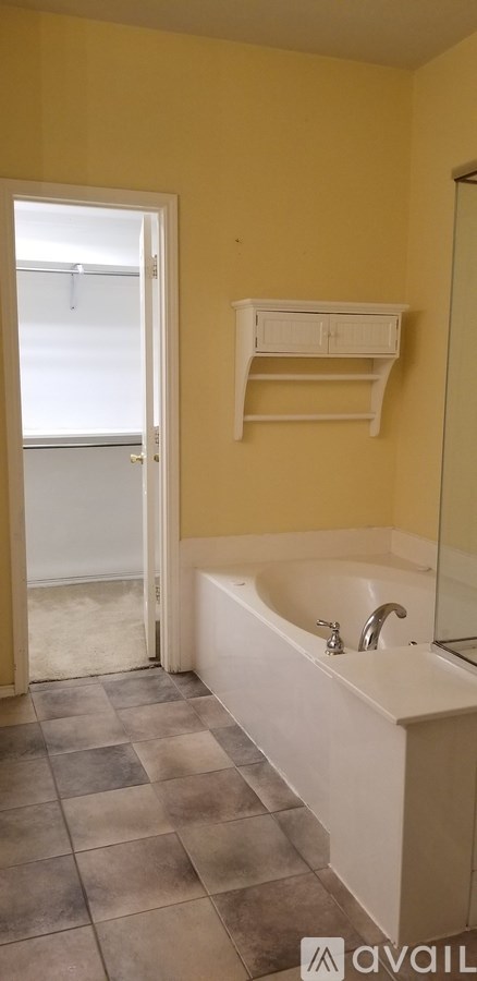 A bathroom with a white tub and a white sink.